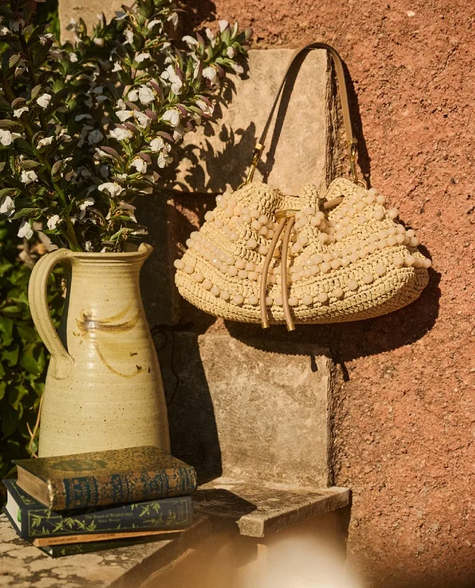 <strong>NATURAL TEXTURES</strong>Handcrafted accessories inspired by sun-soaked destinations.